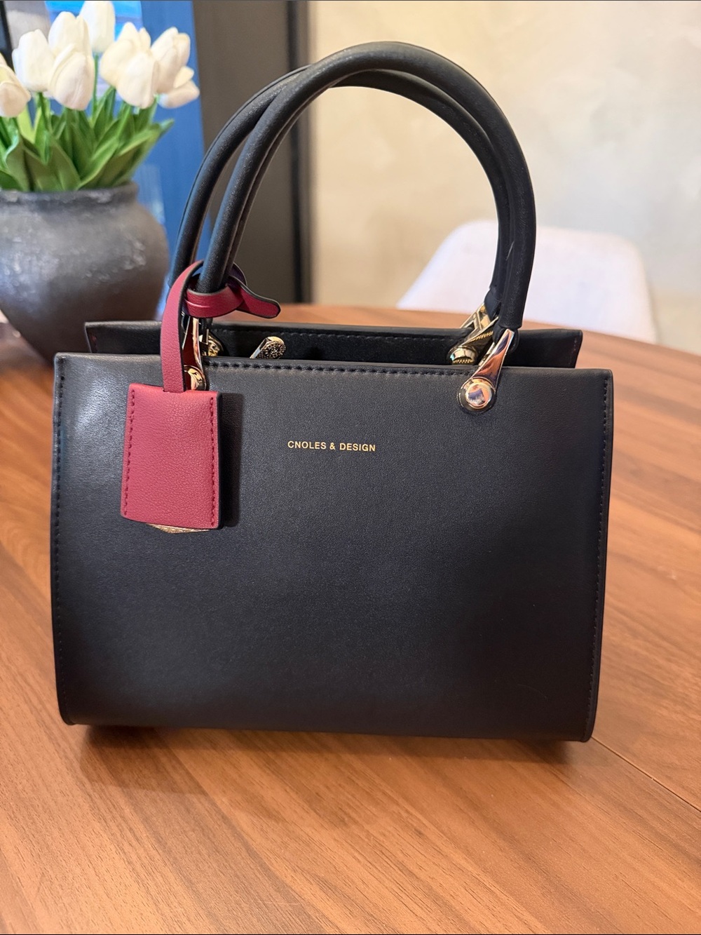 Black Leather Top-Handle Bag with Pink Tag